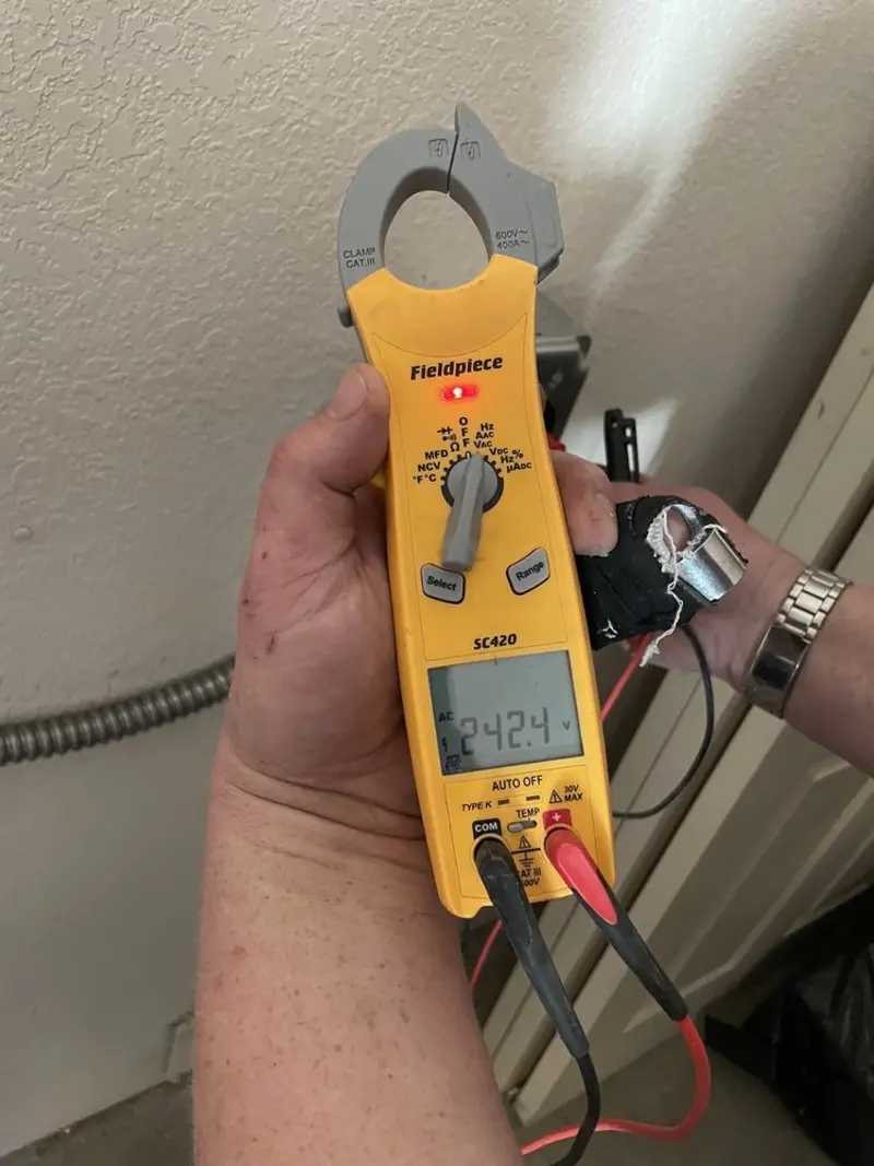 Voltage testing with clamp meter during Recessed Lighting Installation in Rockport